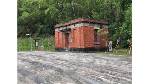 量水器室是磚紅色，位於淨水池下方階梯入口右側，用於量測水道送出之水量。